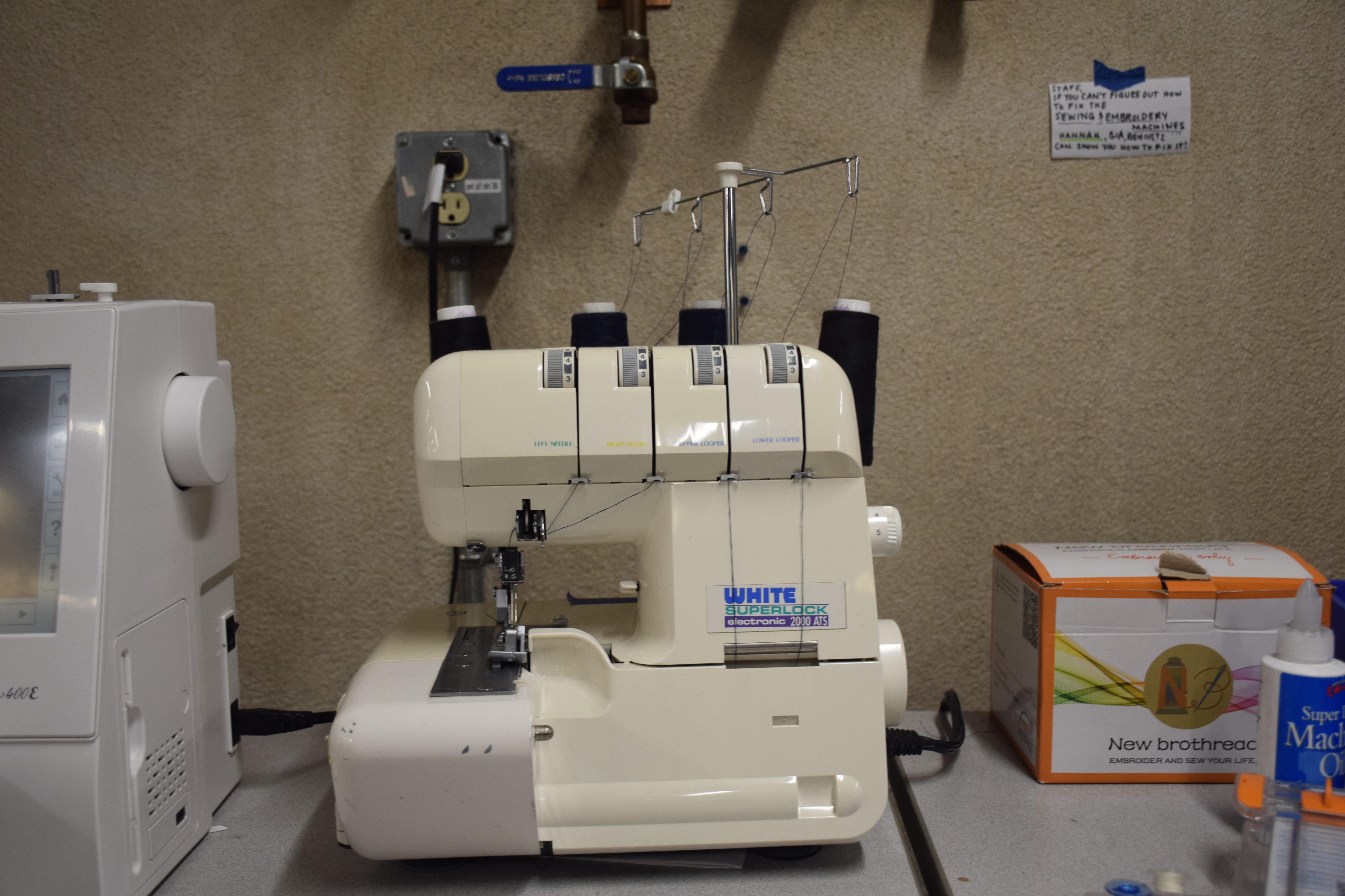 White Serger Machine with 4 Spools of Black Thread