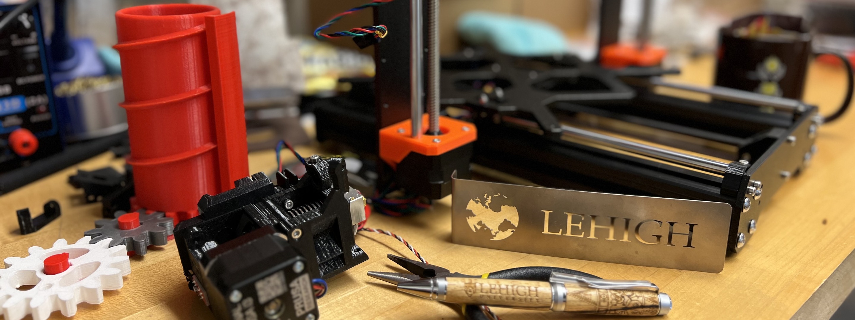 3D printer surrounded by tools and a Lehigh sign