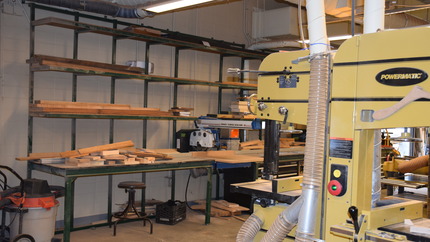 Wall of wood behind a bandsaw