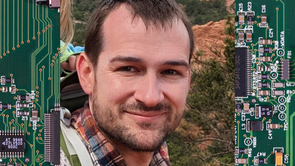 Mike Moore Headshot with Electronics Background