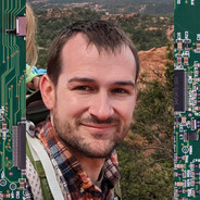 Mike Moore Headshot with Electronics Background